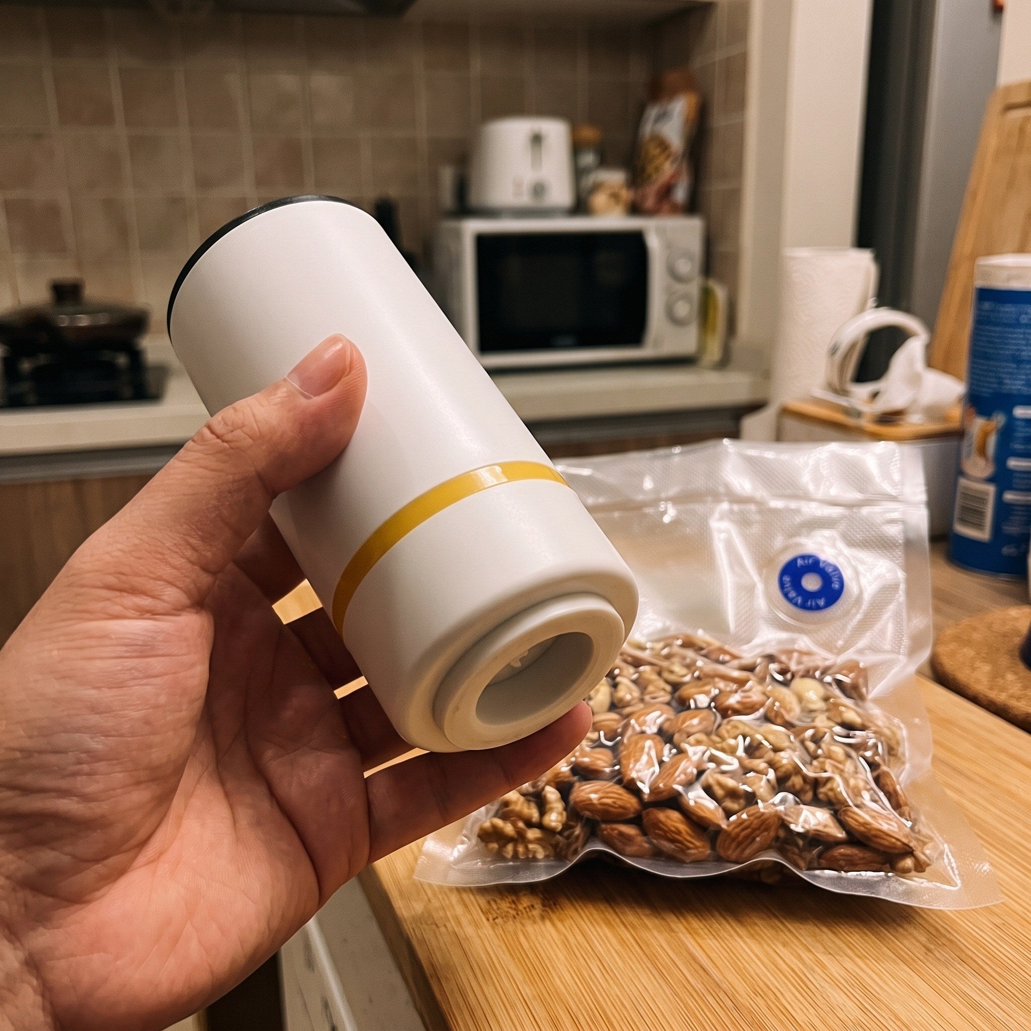 Close view of a hand holding the white pump base